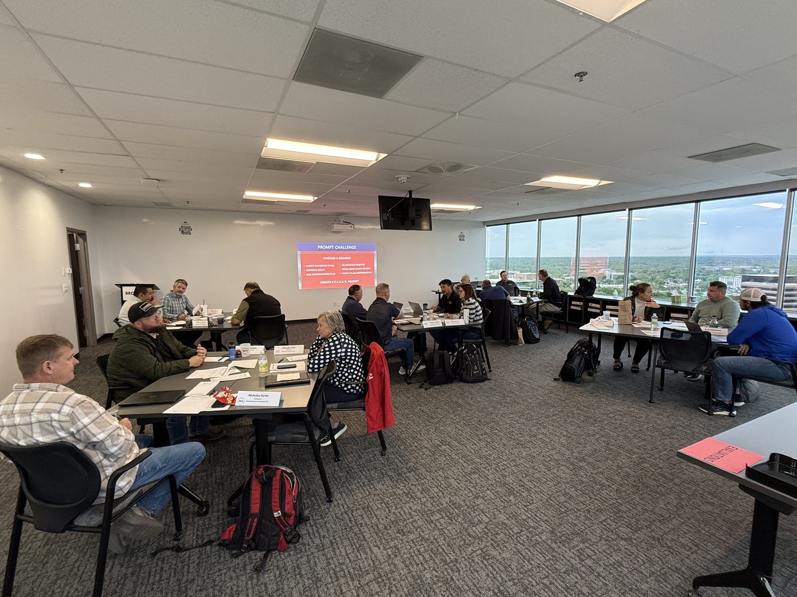 A conference room of construction professionals during an AI workshop A conference room of construction professionals during an AI workshop