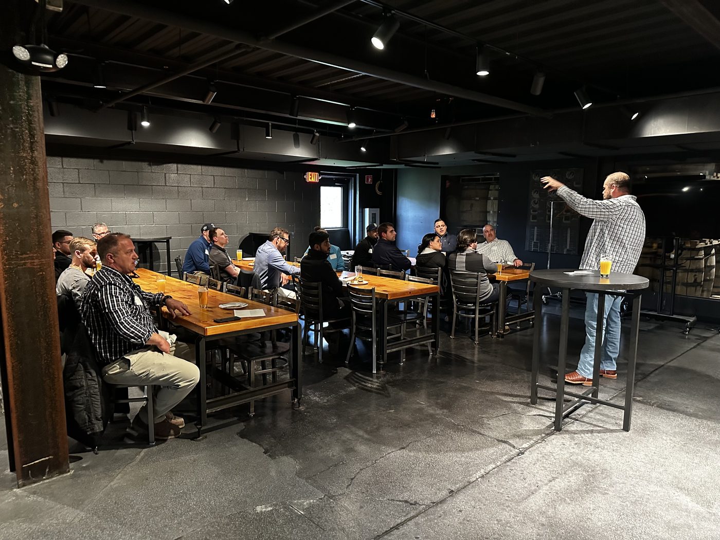 Carl Britton Jr. leading an AI training session for contractors around a work table Carl Britton Jr. leading an AI training session for contractors around a work table