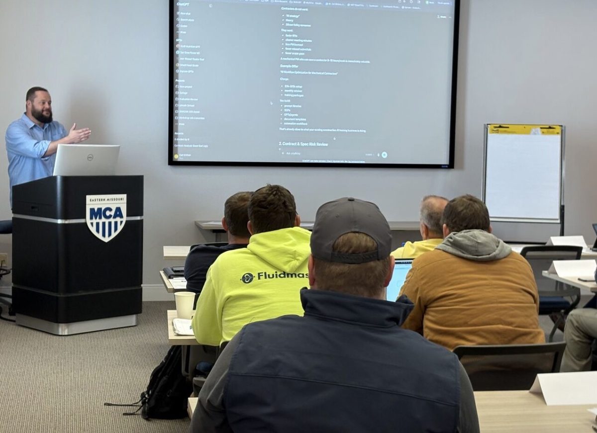 Carl Britton Jr. presenting from a podium at an MCA chapter AI training Carl Britton Jr. presenting from a podium at an MCA chapter AI training